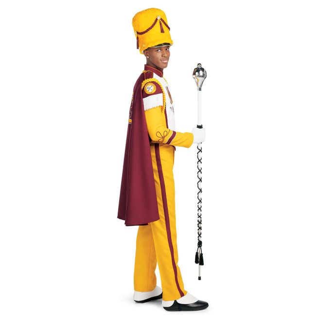 Custom yellow with brick trim marching band uniform. Side view with white gloves and yellow busby hat and pants and brick cape with yellow logo holding amazing mace