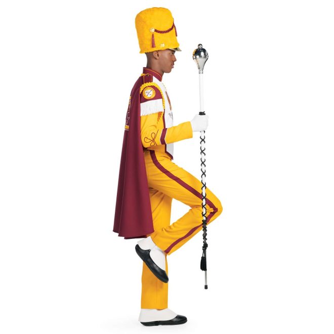 Custom yellow with brick trim marching band uniform. Side view with white gloves and yellow busby hat and pants and brick cape with yellow logo holding amazing mace