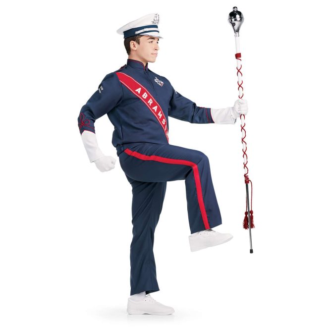 Custom navy with white and red detailing marching band uniform long sleeve. Side view with matching baylay parade cap, white shoes, white gloves, and navy pants holding amazing mace