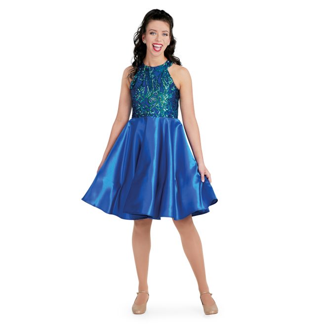 custom show choir dress with goddess neckline in navy irid/ navy sophisticated sequin with flowy knee length skirt on model front view