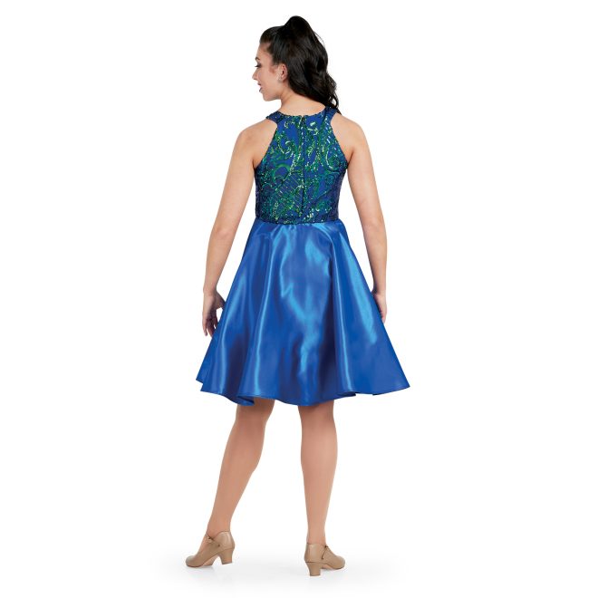 custom show choir dress with goddess neckline in navy irid/ navy sophisticated sequin with flowy knee length skirt on model back view