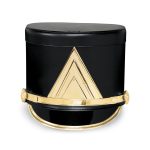 black marching shako with gold hardware and a gold chevron emblem