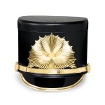 black marching shako with gold hardware and a gold starburst emblem