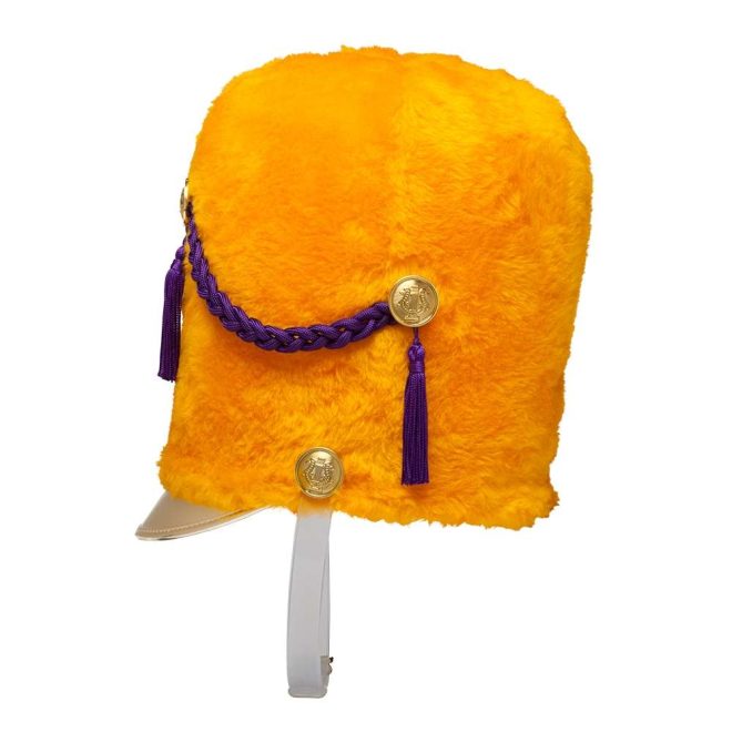 Side view of yellow fur custom marching band busby hat with gold buttons and bill, purple cord, and white strap