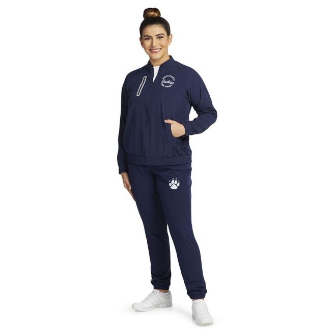 custom navy holloway ladies weld jacket with team name and mascot on left chest. Paired with navy sweatpants with paw print on top left front view on model