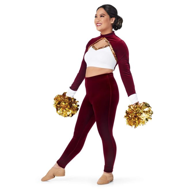 custom maroon long sleeve with white chest and cuffs and keyhole bodice with gold sequin trim crop top with matching maroon pants majorette uniform front view on model holding gold poms