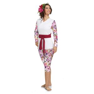 Custom long sleeve color guard capri unitard with tunic over. Unitard is purple and pink floral with white background. Tunic is solid white sleeveless with red belt around waist. Front view on model with red and pink flower in hair