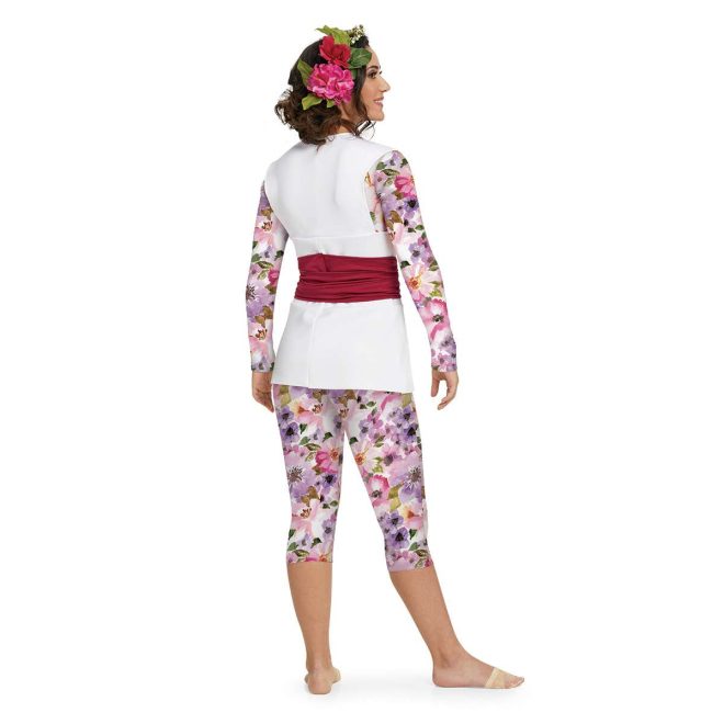 Custom long sleeve color guard capri unitard with tunic over. Unitard is purple and pink floral with white background. Tunic is solid white sleeveless with red belt around waist. Back view on model with red and pink flower in hair