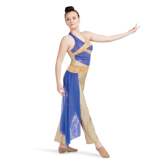 Custom halter top pant color guard unitard. Tan base with gold sequin section around waist and blue mesh ruffle off right hip to floor. Chest has blue mesh with diagonal lines of gold sequin. Front view on model holding lavender flag