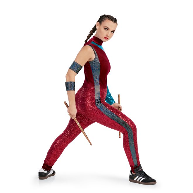 Custom percussion uniform. Red top with one sleeveless arm and one metallic teal sleeve. Sequin red pants side view with two arm cuffs