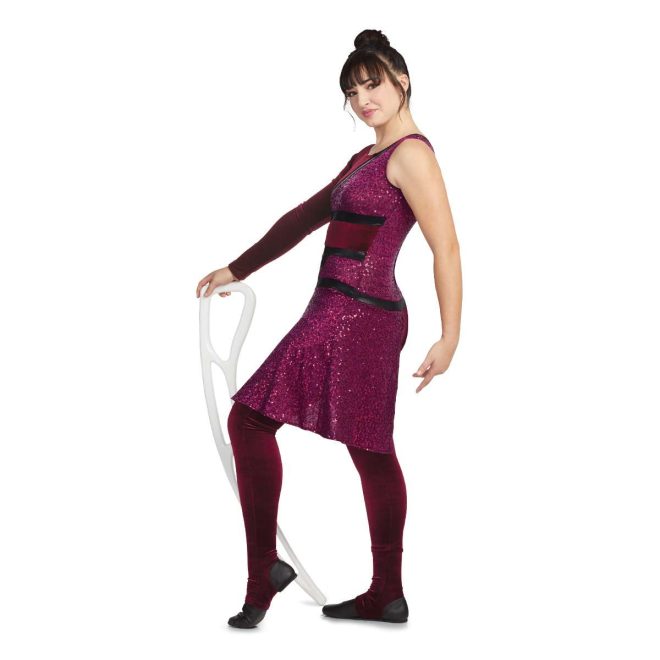 Custom legging color guard unitard. Left sleeveless, right long sleeve velvet maroon. Body mostly maroon sequin up to slanted black stripe from left shoulder to middle right back. Pants are velvet maroon separated from top by black stripe. Maroon sequin drape off left hip. Side view on model holding airblade