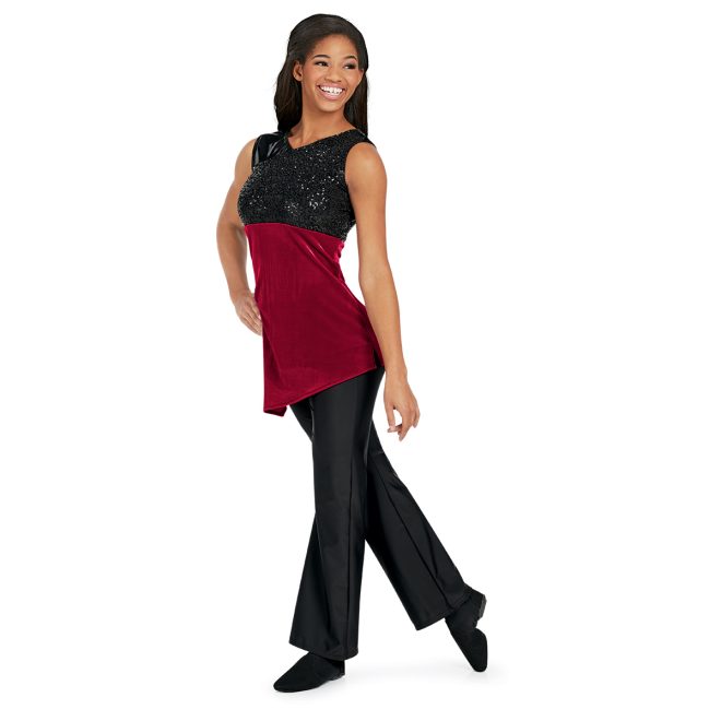 red sleeveless asymmetric skirted color guard tunic shown over black pants front view on model. Black sparkle chest and red body