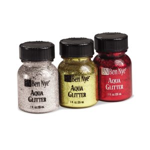 silver, gold and red containers of ben nye aqua glitter