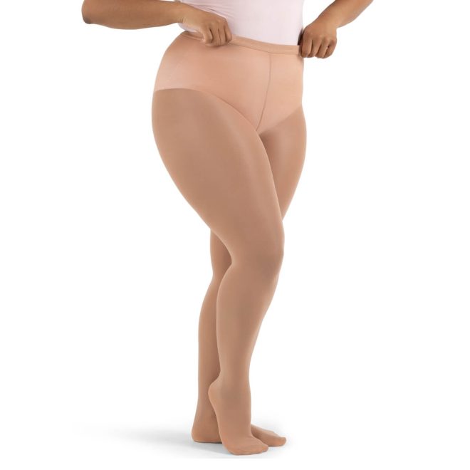 Model wearing light suntan Capezio Hold and stretch plus sized Footed Tights, front three-quarters view