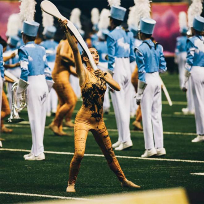white dsi arc 1 color guard rifle held by performer on football field