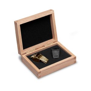 gold award whistle with light brown wooden box and black felt