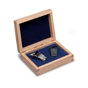 silver award whistle with light brown wooden box with royal felt