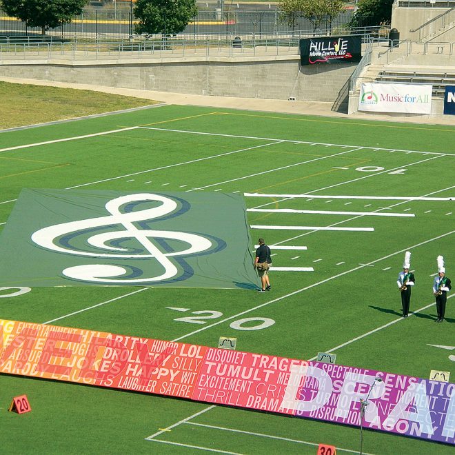 treble clef digitally printed field and floor tarp being used during performance on football field