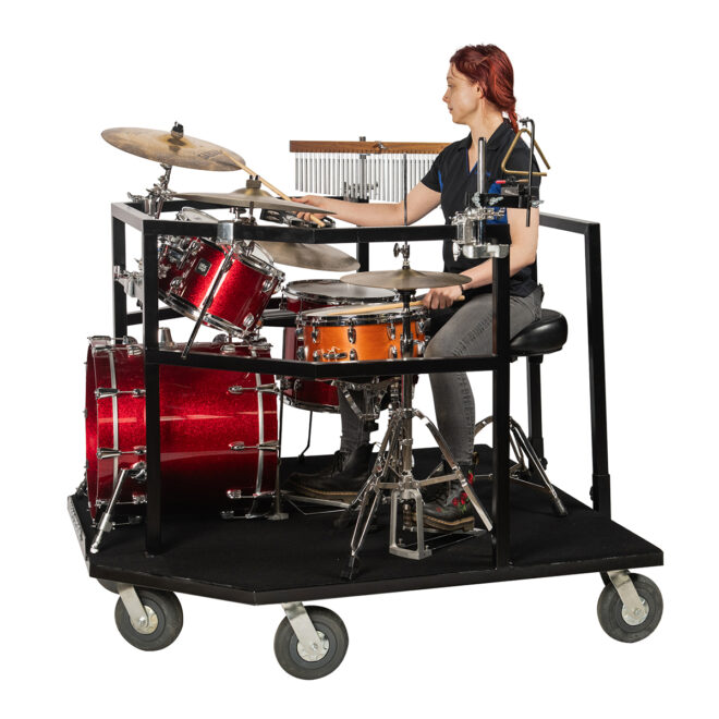 Black Corps Design Drum Set cart with equipment and a musician playing drums, side view
