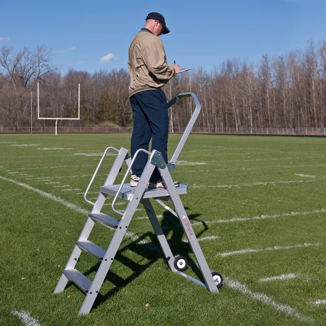 stageright 42 inch marching band podium on football field with man standing on it