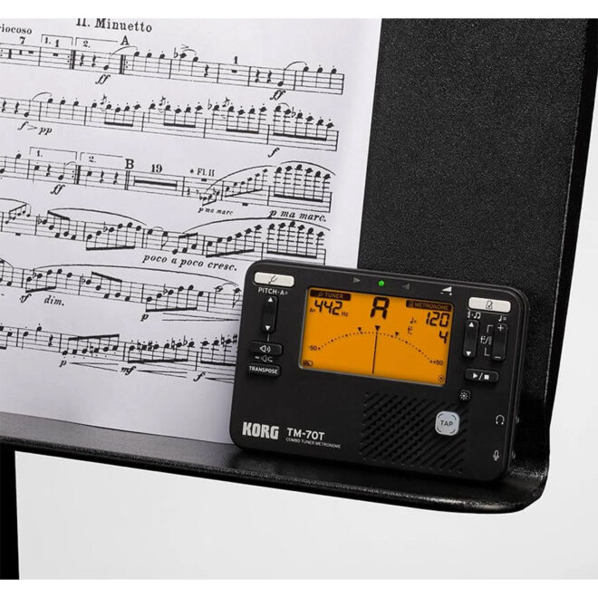 korg tm70 music tuner and metronome on a music stand with sheet music