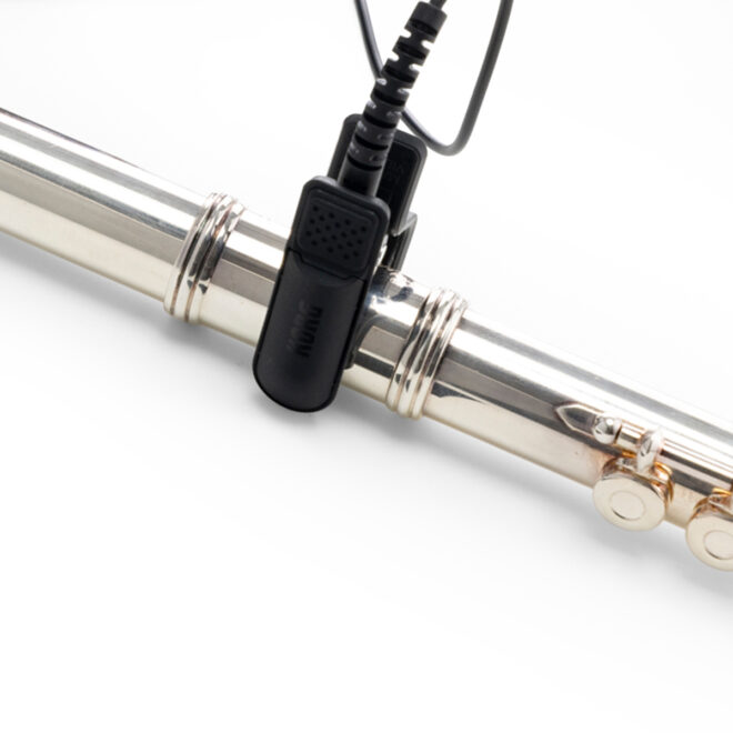 black KORG CM400 Contact Mic clipped to a flute
