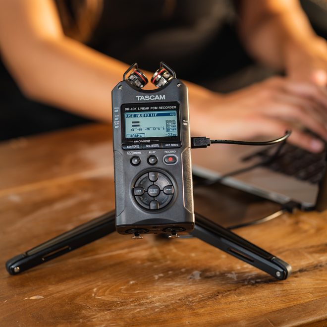 tacsam handheld audio recorder dr40x on stand in front of person