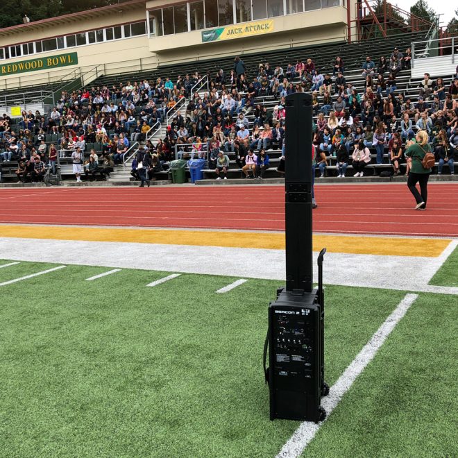 anchor audio beacon 2 basic package side view with speakers fanned out in front of crowd on football field