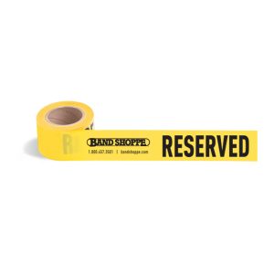 yellow reserved flagging tape roll partially unrolled with band shoppe logo