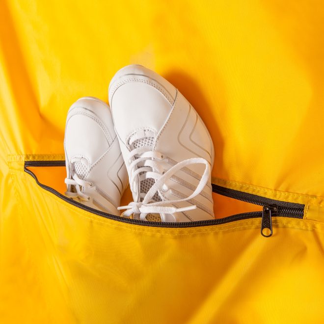 gold deluxe garment bag with white shoes