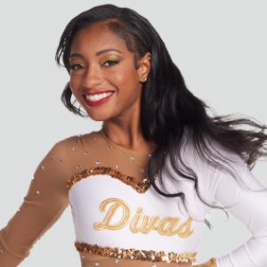 majorette wearing a flashy white and gold sequin uniform